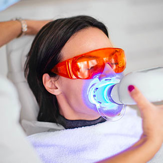 Woman undergoing teeth whitening procedure